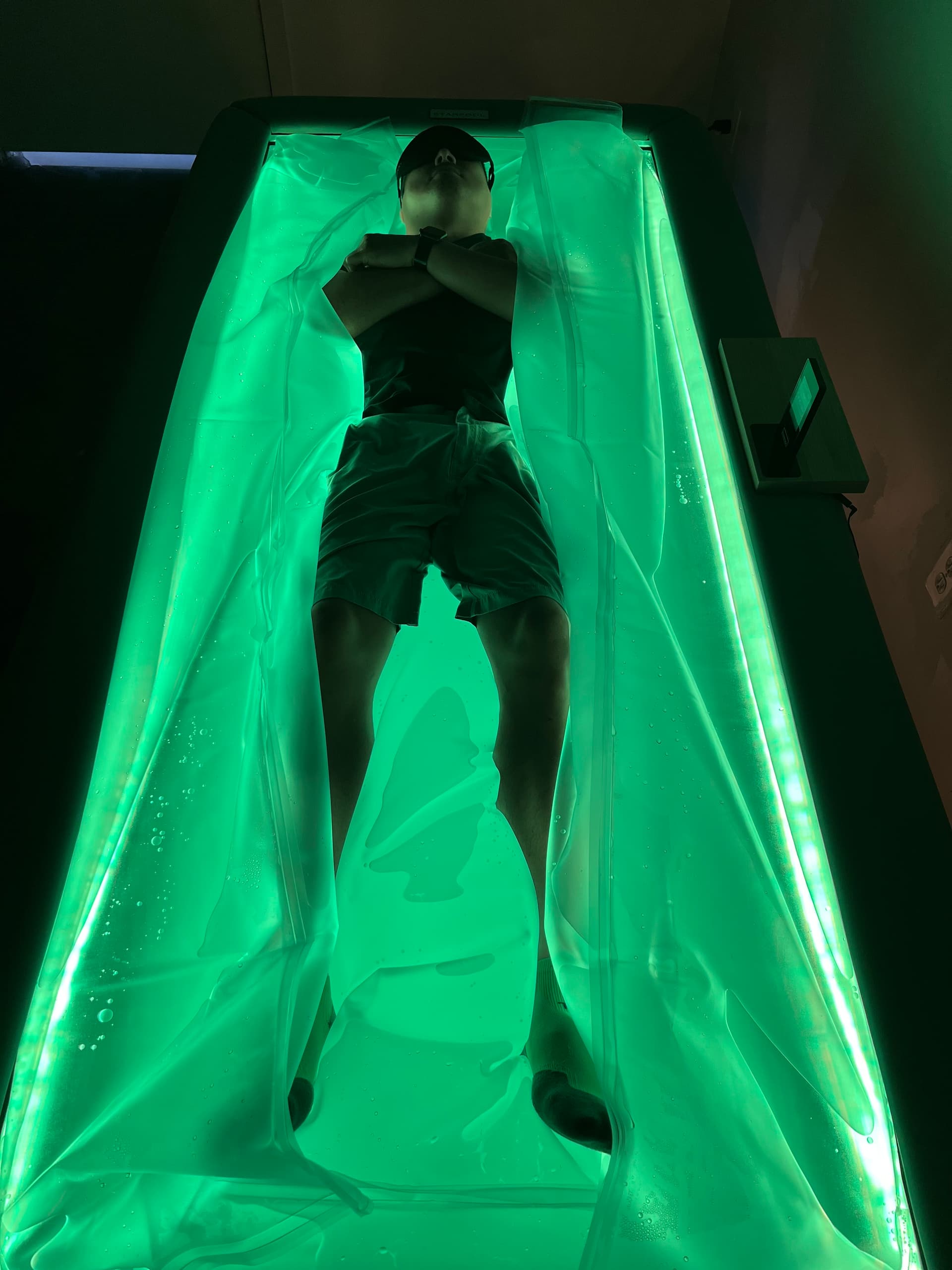 Overhead view of client on Starpool dry float bed with green ambient lighting